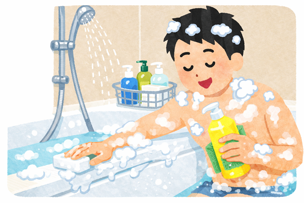 風呂に入りながら浴槽を洗う男性